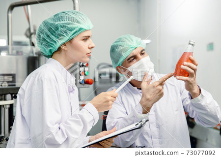 Quality control and food safety team inspection the product standard in the food and drink factory production line. 73077092