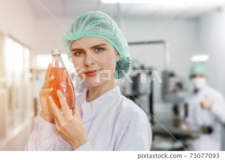beautiful woman  holding juice drink in bottle for advance science beverage product for beauty and healthy women concept 73077093