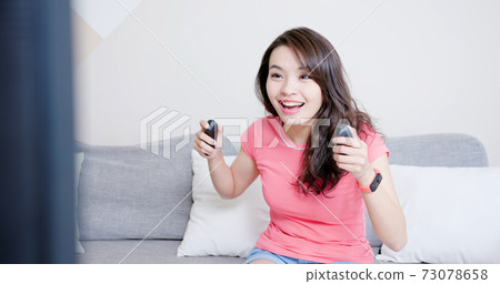 woman play motion sensing game 73078658