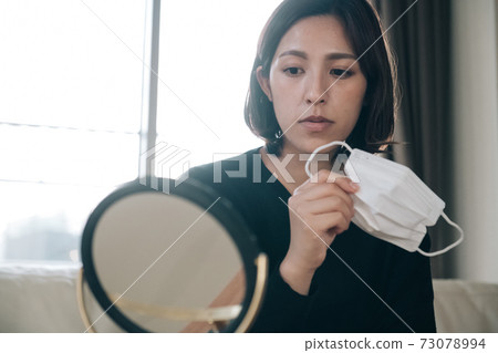 A woman who cares about rough skin caused by a mask A woman who cares about rough skin caused by a mask 73078994