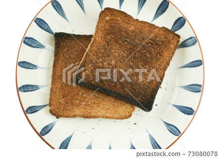 The bread is burnt and cannot be eaten. The bread is burnt and cannot be eaten. 73080078