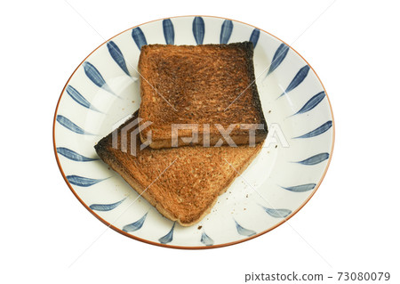 The bread is burnt and cannot be eaten. The bread is burnt and cannot be eaten. 73080079