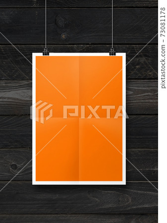 Orange folded poster hanging on a concrete wall with clips Orange folded poster hanging on a concrete wall with clips 73081178