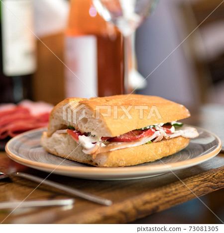 Tasty sandwich with red wine on the table Tasty sandwich with red wine on the table 73081305