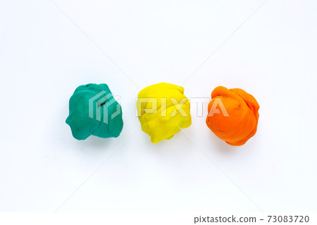 Colorful plasticine clay on white background. Colorful plasticine clay on white background. 73083720