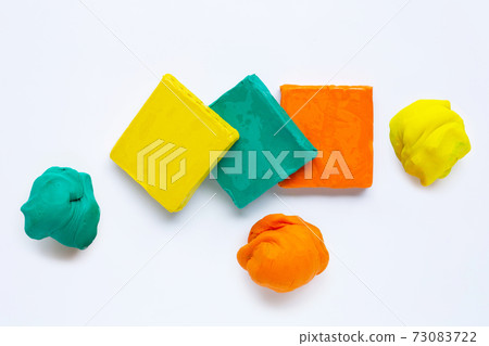 Colorful plasticine clay on white background. Colorful plasticine clay on white background. 73083722