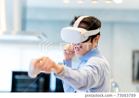 A man experiencing virtual reality in VR A man experiencing virtual reality in VR 73083789