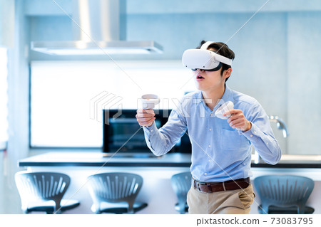 A man experiencing virtual reality in VR A man experiencing virtual reality in VR 73083795