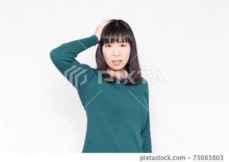 拿著她的頭的婦女站立在白色背景前面 73083803