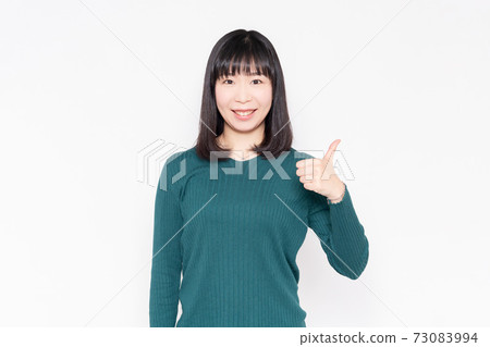 站立在白色背景前面和做一個喜歡姿態的婦女 站立在白色背景前面和做一個喜歡姿態的婦女 73083994