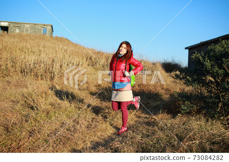 girl trekking in winter of hong kong 73084282