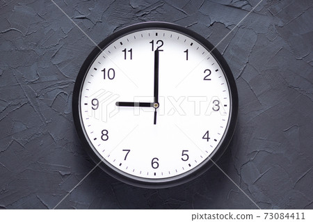 wall clock at dark grey painted background wall clock at dark grey painted background 73084411