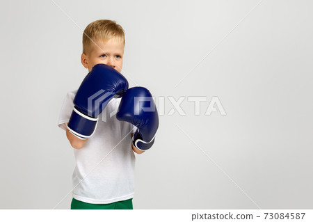 Boxing fighter boy in boxer gloves Boxing fighter boy in boxer gloves 73084587
