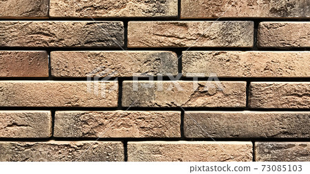 Old orange vintage wall made of craft stones Old orange vintage wall made of craft stones 73085103