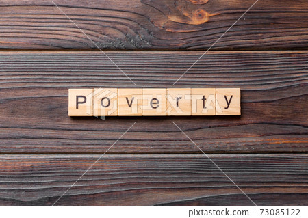 Poverty word written on wood block. Poverty text on cement table for your desing, concept Poverty word written on wood block. Poverty text on cement table for your desing, concept 73085122