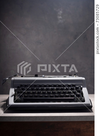 old retro typewriter at wooden table 73085729