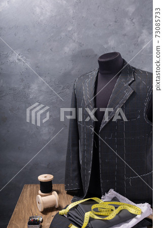 suit jacket on male tailor mannequin and sewing tools suit jacket on male tailor mannequin and sewing tools 73085733