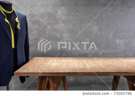 wooden table and suit jacket on male tailor mannequin 73085786