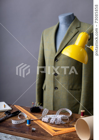 suit jacket on male tailor mannequin and sewing tools, 73085858