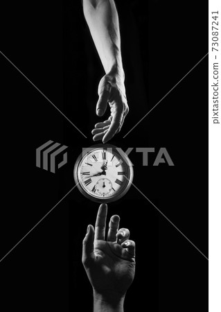 Touch of time - hands touching a clock with numbers Touch of time - hands touching a clock with numbers 73087241