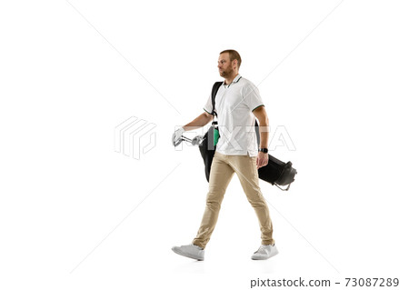 Golf player in a white shirt practicing, playing isolated on white studio background Golf player in a white shirt practicing, playing isolated on white studio background 73087289