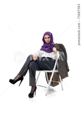 Beautiful arab woman posing in stylish office attire isolated on studio background. Fashion concept 73087363