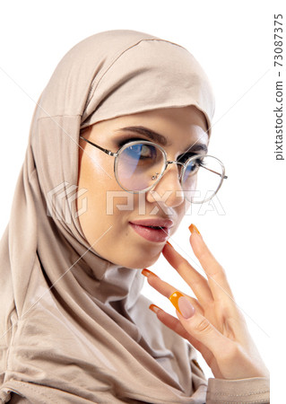 Beautiful arab woman posing in stylish hijab isolated on studio background. Fashion concept 73087375