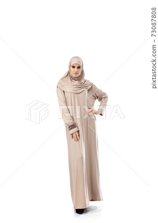 Beautiful arab woman posing in stylish hijab isolated on studio background. Fashion concept 73087808