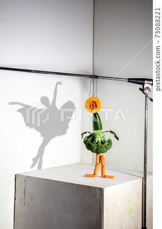 Flying food composition making beautiful ballerina drawing shadow on the wall Flying food composition making beautiful ballerina drawing shadow on the wall 73088221