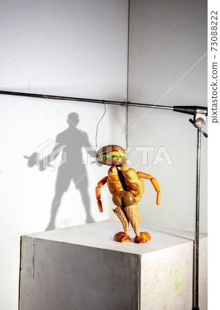 Flying food composition making beautiful sportsman drawing shadow on the wall Flying food composition making beautiful sportsman drawing shadow on the wall 73088222
