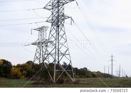 High voltage transmission line. High voltage power tower and nature landscape at day. High voltage transmission line. High voltage power tower and nature landscape at day. 73088725