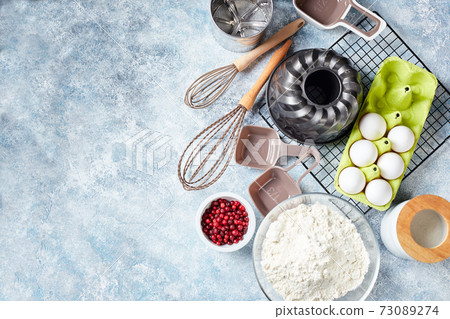 Baking ingredients and utensils, flour, eggs, baking dish. Baking ingredients and utensils, flour, eggs, baking dish. 73089274
