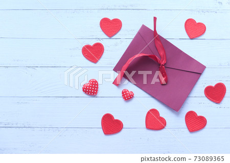 red color envelope and red heart on white background  73089365