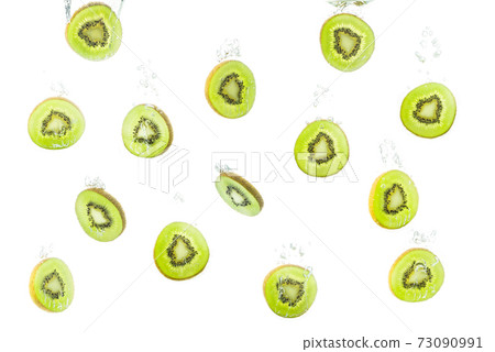 Pattern with kiwi slices sinking in water against white . Pattern with kiwi slices sinking in water against white . 73090991