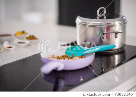 Preparing food in modern white kitchen Preparing food in modern white kitchen 73092140