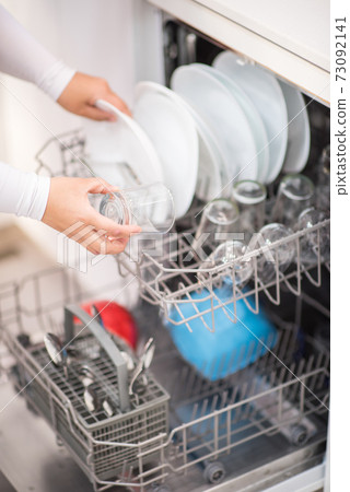 Open dishwasher with clean glass and dishes Open dishwasher with clean glass and dishes 73092141