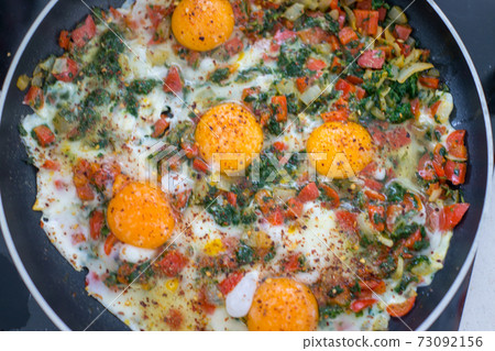 In the course of making breakfast with fresh eggs and vegetables In the course of making breakfast with fresh eggs and vegetables 73092156