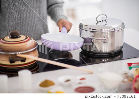 Preparing food in modern white kitchen Preparing food in modern white kitchen 73092161