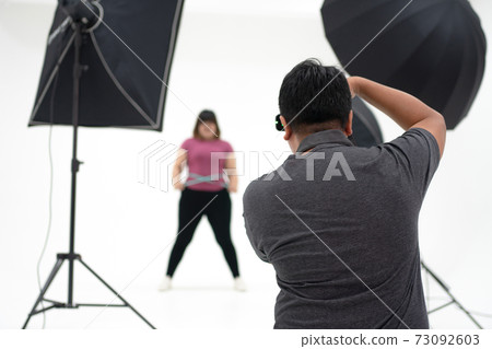 photographer take a photo in the studio 73092603