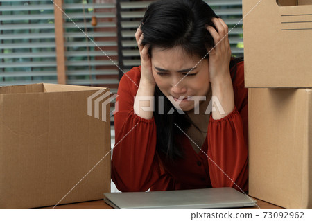 Sad Asian woman Packing belongings in a cardboard box and crying on the desk in the office After being layoff and unemployed. Concept of impact on the economic downturn And management of the failure Sad Asian woman Packing belongings in a cardboard box and crying on the desk in the office After being layoff and unemployed. Concept of impact on the economic downturn And management of the failure 73092962