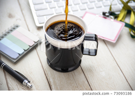 Coffee placed on the office table Coffee placed on the office table 73093186