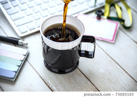 Coffee placed on the office table 73093193