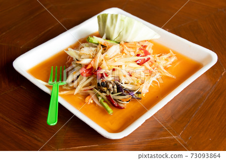 Papaya salad, Thai food name Som Tum, on white foam plate background 73093864