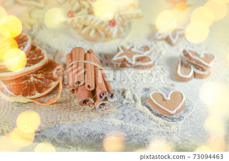 Cookies and Christmas cinnamon decor on wooden table. Cookies and Christmas cinnamon decor on wooden table. 73094463