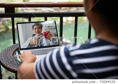 Asian doctor or therapist help relieve stress and provide knowledge and understanding about heart disease to patients video conference call online live talk remotely at home Asian doctor or therapist help relieve stress and provide knowledge and understanding about heart disease to patients video conference call online live talk remotely at home 73094526