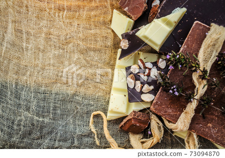 Black, white, milk chocolate pieces. Many types of chocolate Black, white, milk chocolate pieces. Many types of chocolate 73094870