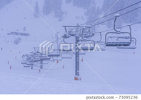 Empty ski slopes and ski lifts in Auron ski resort, France. During the winter holidays of 2020 December and 2021 January lifts are closed for skiing for adults due to the coronavirus pandemic. Empty ski slopes and ski lifts in Auron ski resort, France. During the winter holidays of 2020 December and 2021 January lifts are closed for skiing for adults due to the coronavirus pandemic. 73095236