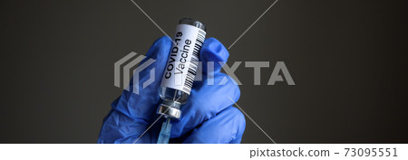 COVID-19 vaccine and syringe in doctor`s hands 73095551