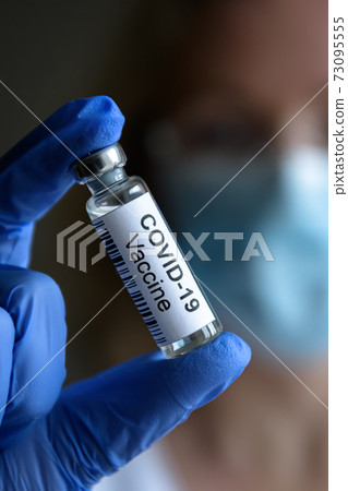 COVID-19 vaccine in doctor`s hand close-up COVID-19 vaccine in doctor`s hand close-up 73095555