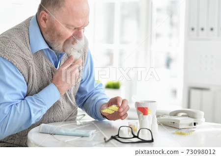 Portrait of an elder man making inhalation Portrait of an elder man making inhalation 73098012